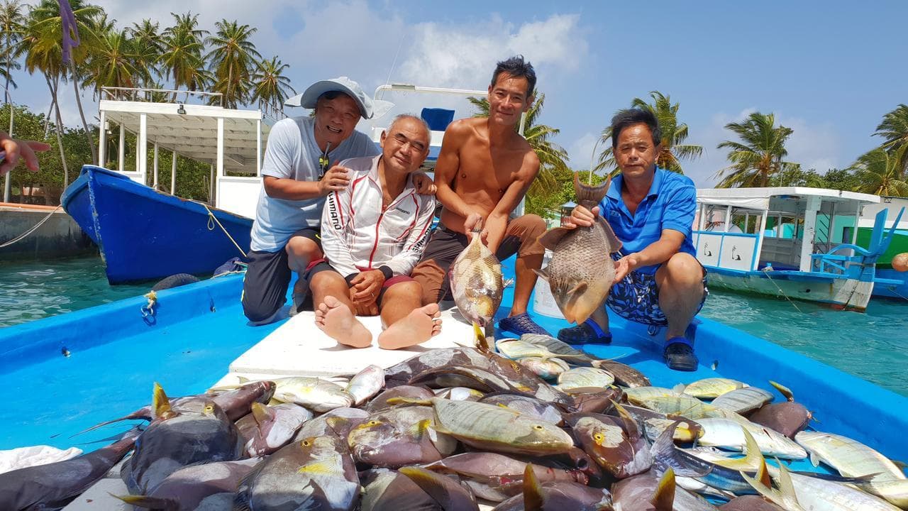 Local fishermen with the day's catch on a boat near Himmafushi