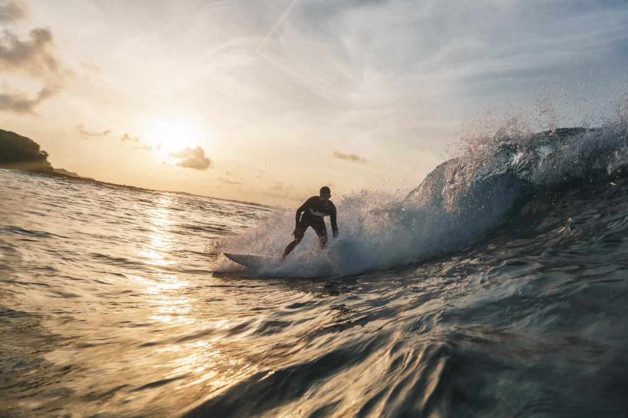 Surfer in a sunset barrel in North Malé Atoll