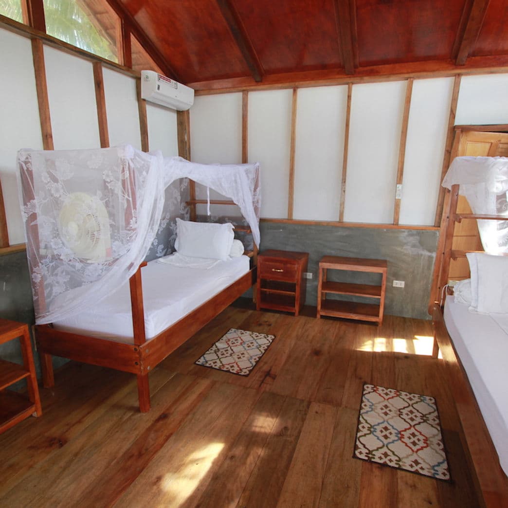 Air-conditioned bungalow bedroom with mosquito nets