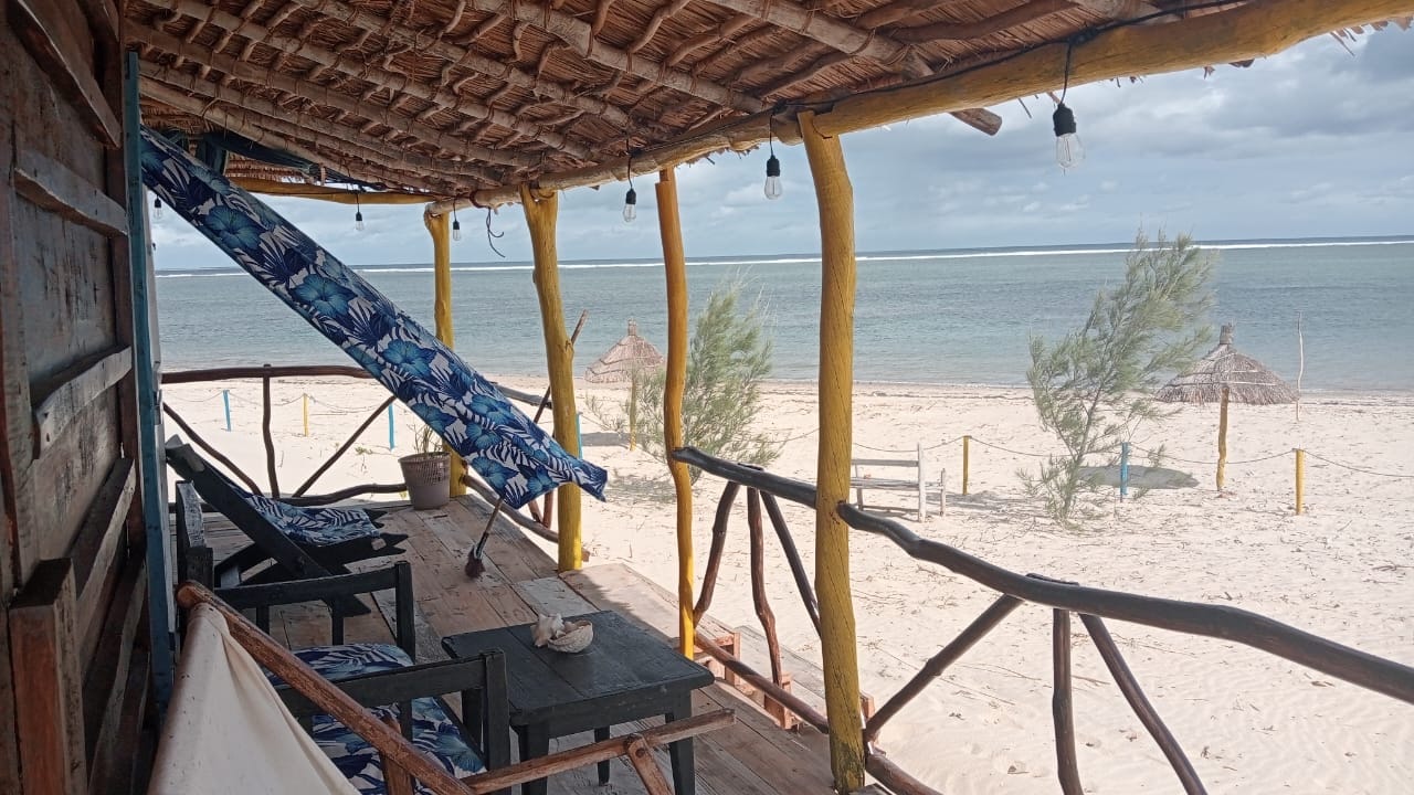 Shaded terrace at Chez Andrea looking across the sand to the Indian Ocean