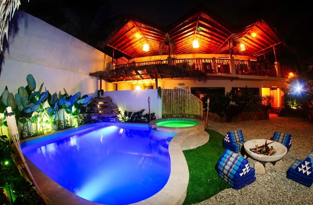 Garden pool and jacuzzi lit up blue and green at night